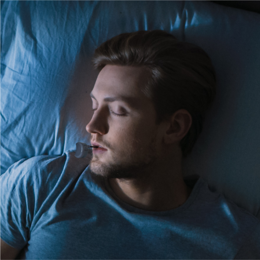 Man sleeping peacefully in bed wearing a Zerene smart mouthguard