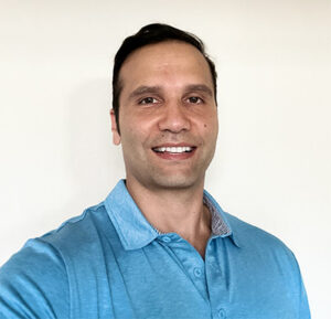 Headshot of Zerene Inc founder Arash Sabet wearing a blue collared shirt.